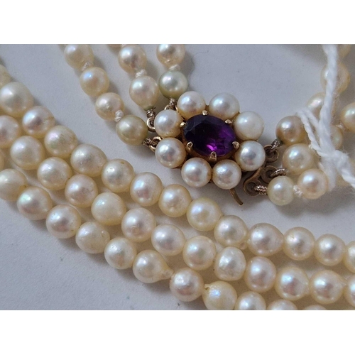 275 - A three strand pearl necklace with 9ct amethyst clasp 13 inch