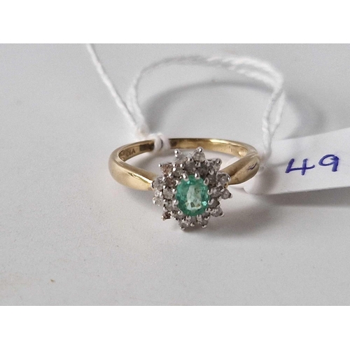 49 - Emerald & Diamond dress ring with double row of diamonds framing the central Emerald 9ct size M