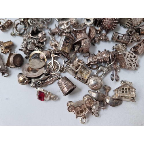 81 - A large quantity of silver charms 206 gms