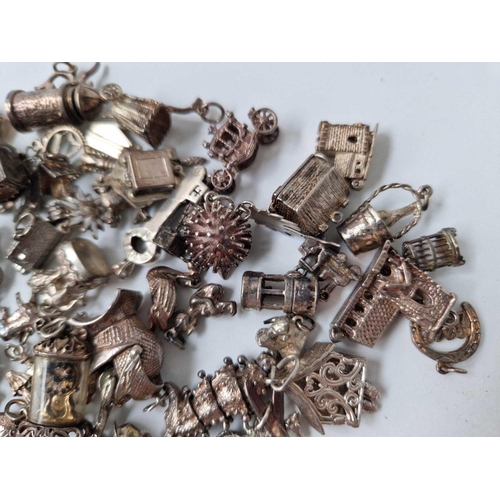 81 - A large quantity of silver charms 206 gms