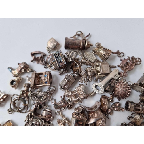 81 - A large quantity of silver charms 206 gms