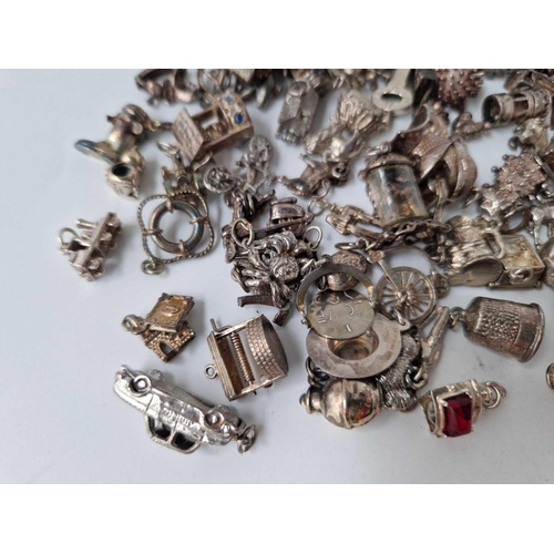 81 - A large quantity of silver charms 206 gms