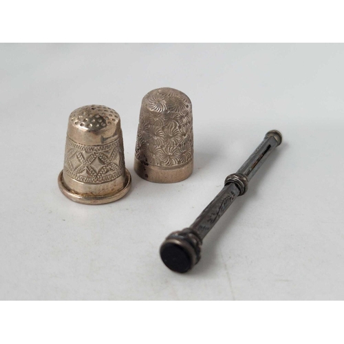 83 - Two silver thimbles and a pencil