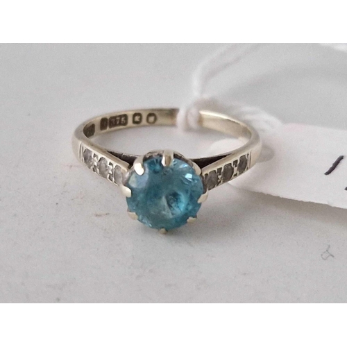 17 - A blue zircon ring with diamond shoulders 9ct size N 2.6 gms