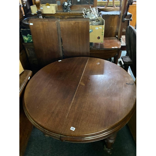 1716 - A Victorian mahogany extending dining table with turned legs and three leaves with winder