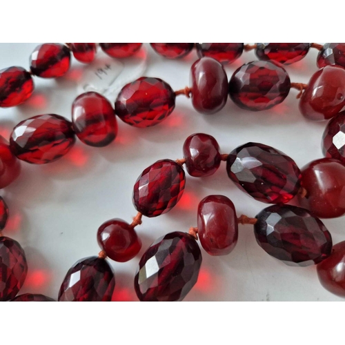 194 - A long row of amber type beads 34 inch