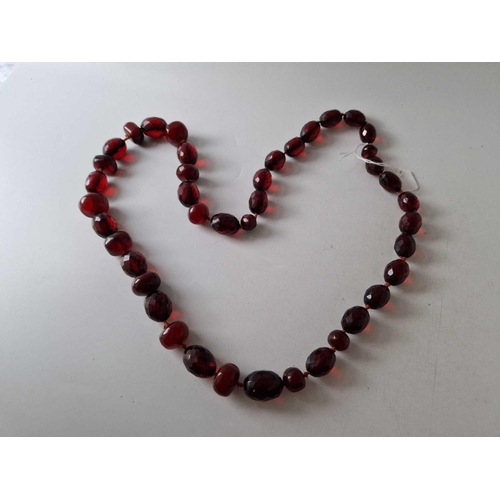 194 - A long row of amber type beads 34 inch