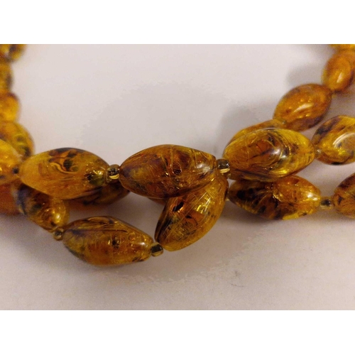 219 - A three row amber style bead necklace 14 inch