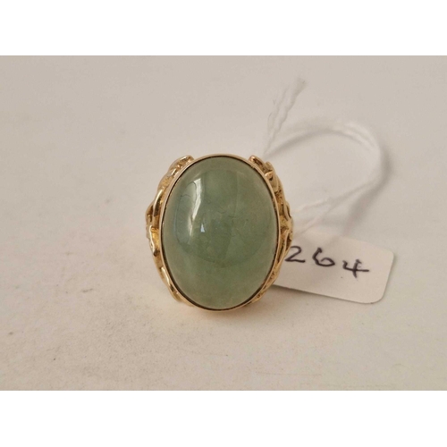 264 - 9ct fancy ring set with a cabochon jade with Art Nouveau styling to the shoulders, hallmarked