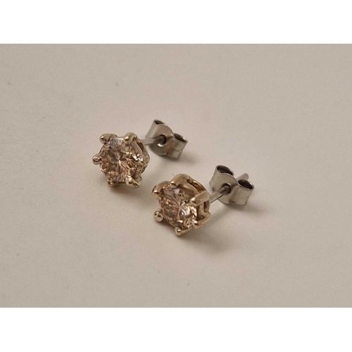 265 - Pair of 18ct and platinum diamond stud earrings weighing a total of 0.95 cts Birmingham 1976, size R... 