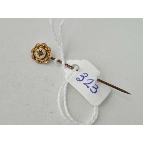 323 - A diamond topped stick pin 9ct