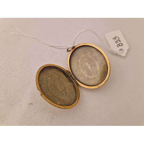 333 - A gilt oval double sided locket