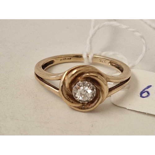 69 - A diamond cluster ring with small diamonds around a larger central stone 9ct size Q 3 gms