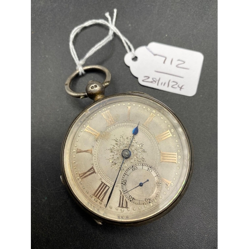 712 - A large silver pocket watch with silvered face and seconds dial