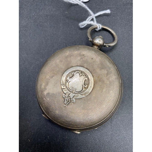 712 - A large silver pocket watch with silvered face and seconds dial