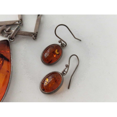 96 - A silver and amber pendant on chain and earrings 51 gms