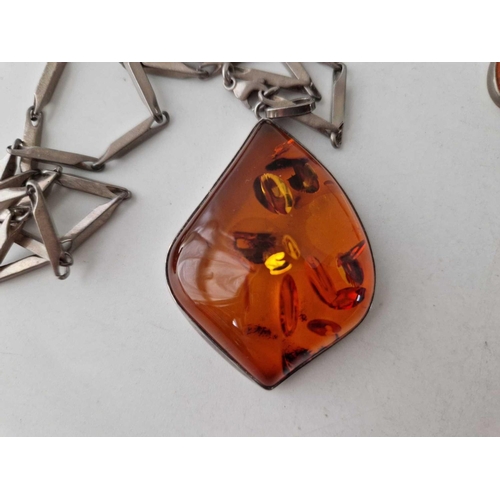 96 - A silver and amber pendant on chain and earrings 51 gms