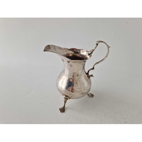 989 - An early George III cream jug on three legs, 4.5 inches high, London 1769 by EM