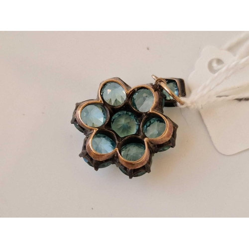 1 - A attractive blue zircon eight stone flower pendant set in gold