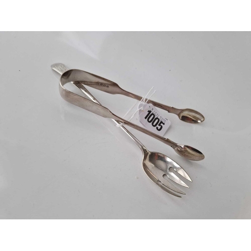 1005 - A pair of fiddle pattern sugar tongs, London 1858 & a plated runcible spoon