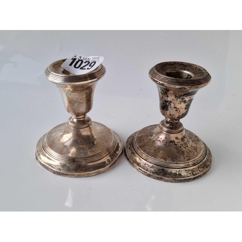 1029 - A pair of candlesticks with reeded rims, 3