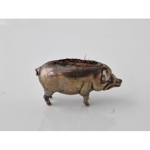 1080 - Pin cushion in form of a standing pig and marked rubbed