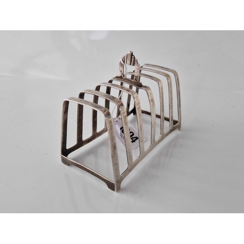 1094 - Seven bar toast rack on bracket feet 5 in long. Birmingham 1936. 121gms