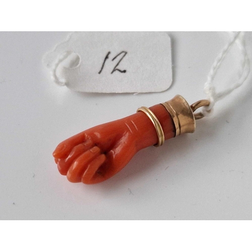 12 - A Victorian gold and coral hand pendant