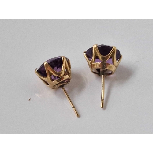 140 - Pair of Amethyst gold stud earrings in coronet claw settings, the amethyst each measure approx 11mm ... 