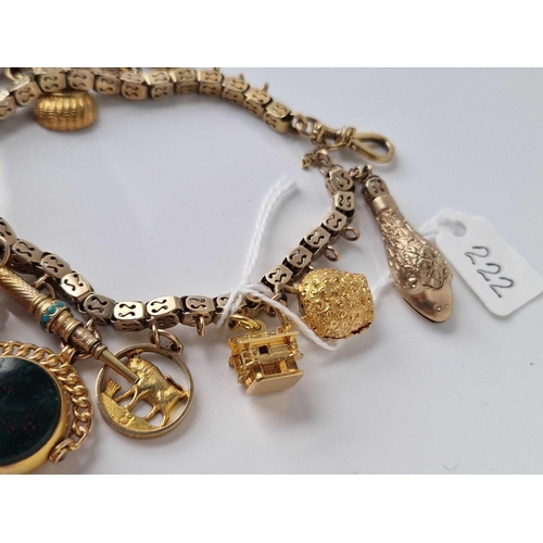 222 - A GOOD GOLD CHARM BRACELET WITH NUMEROUS CHARMS 9CT 7 INCH 64.6 GMS