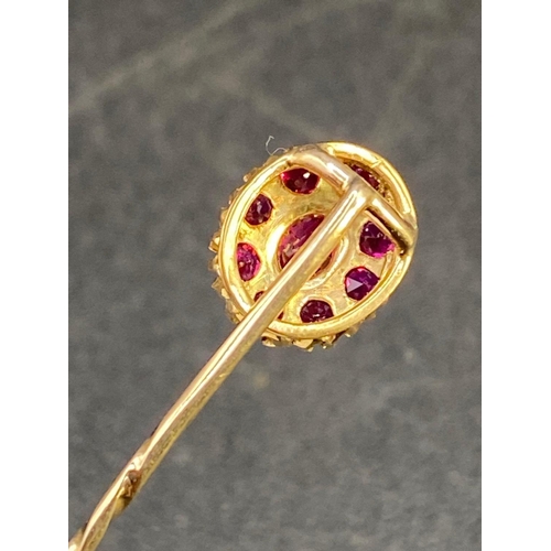 247 - A antique fine ruby stick pin surrounded by ruby cluster in high carat gold