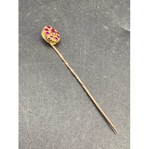 247 - A antique fine ruby stick pin surrounded by ruby cluster in high carat gold