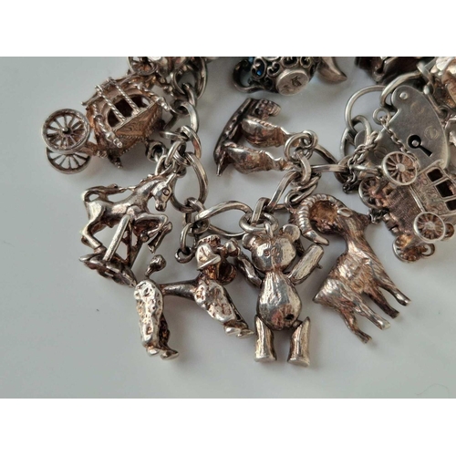 28 - A silver charm bracelet 7 inch 92 gms