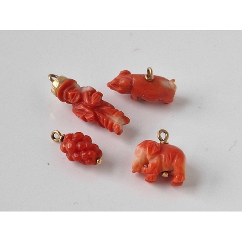 284 - Four gold mounted coral charms