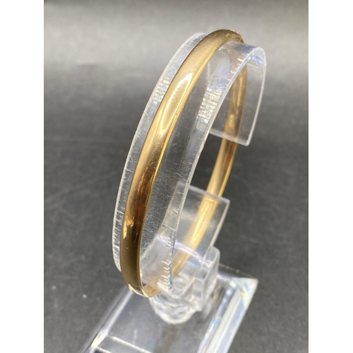 347 - A Victorian gold oval bangle with flush secret opener 5.3g