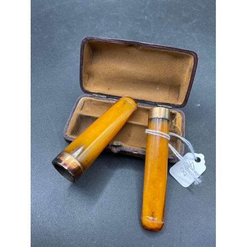 408 - Two good amber gold mounted cheroot holders unoriginal case