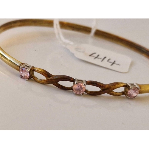 414 - A pink stone set bangle 9ct 3.9 gms 6cm diameter