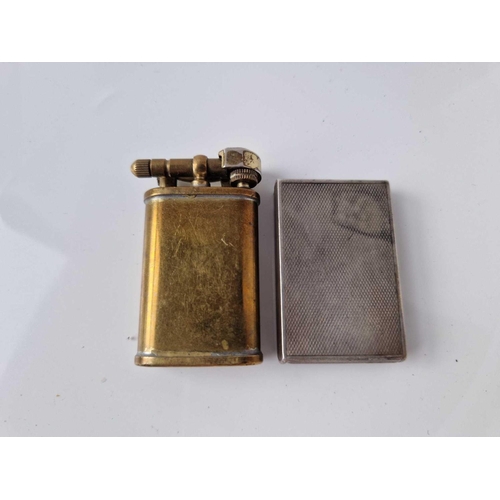 428 - A silver lighter together with a brass example