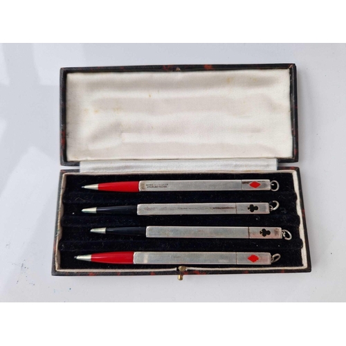 521 - A cased set of four silver bridge pencils