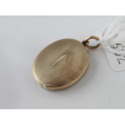 532 - A oval engraved back and front locket 9gms