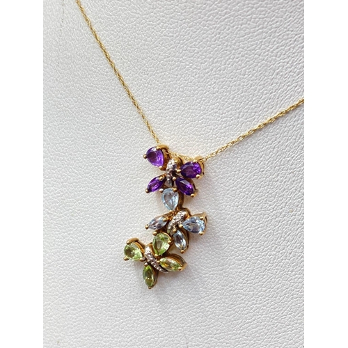 548 - A charming diamond triple butterfly gem pendant set with topaz amethyst and peridots with gold chain... 