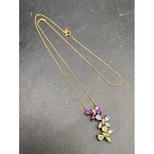 548 - A charming diamond triple butterfly gem pendant set with topaz amethyst and peridots with gold chain... 