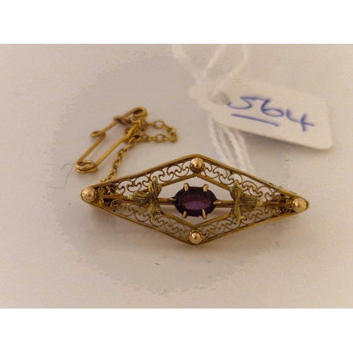 564 - A lozenge shaped brooch with filagree work and central amethyst 10ct gold 2.5 gms