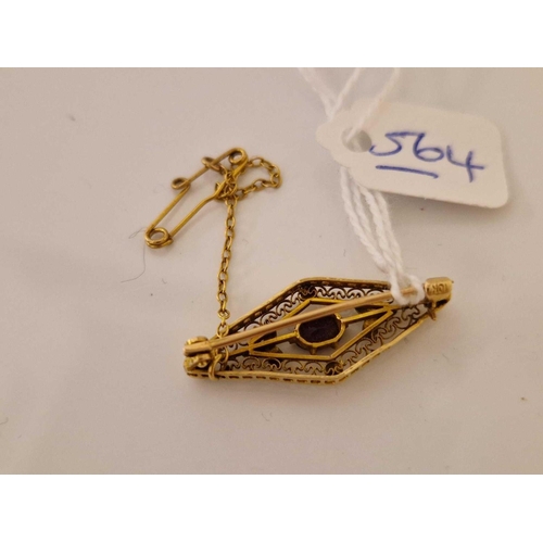 564 - A lozenge shaped brooch with filagree work and central amethyst 10ct gold 2.5 gms