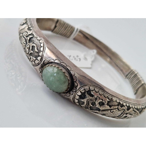 582 - A Chinese silver bangle with jadeite stone