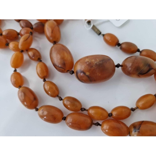 583 - A old string of amber type beads 34 inch