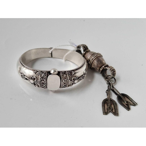 666 - A vintage silver tribal bangle together with silver hand of Fatima pendant