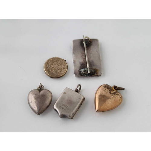 701 - A bag of four lockets and a brooch