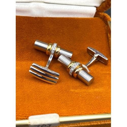 743 - A PAIR OF DIAMOND TWO COLOUR DRESS CUFFLINKS 18CT GOLD THE SOLID TUBE DESIGN ENCIRCLED BY DIAMONDS B... 