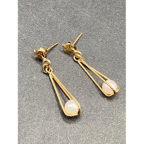 748 - A Pair of Gold Drop Earrings with Fleur de lis detail